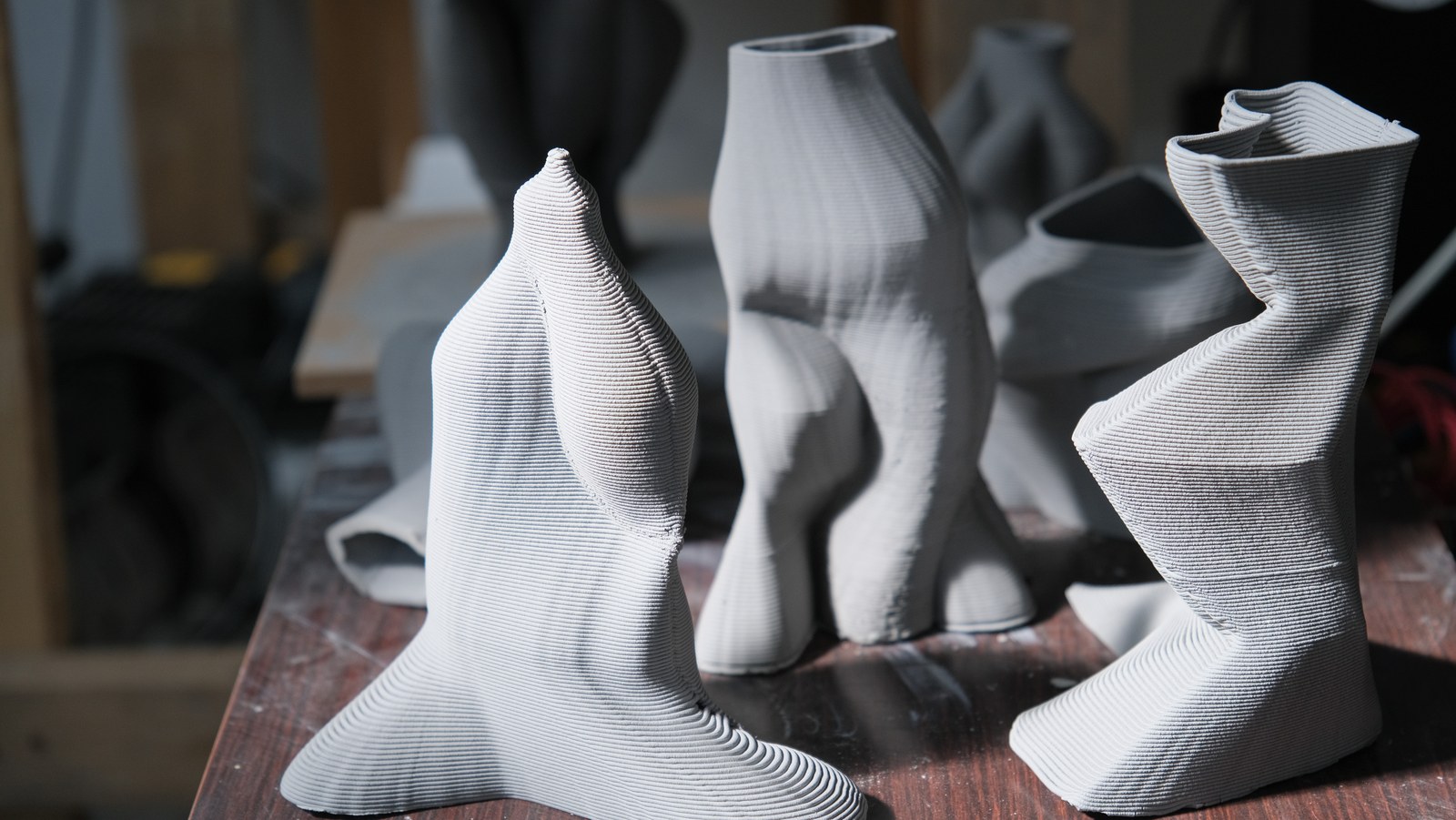 A group of distinct printed clay forms standing together
